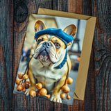 The French Bulldog in Paris Greeting Card by Countryside Greetings features a French Bulldog in a blue beret with onions and the Eiffel Tower, set on wood beside a brown envelope—printed eco-friendly.