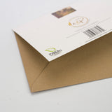 An A5 Gardening Greeting Card by Countryside Greetings, featuring elegant verbena flowers and a green carbon capture logo, is partially covering a brown envelope on a plain white background for an eco-friendly presentation.
