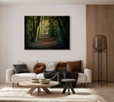 A modern living room with a white sofa, earth-toned pillows, a round wooden coffee table, and Ancient Hampshire track limited editions Giclee wall art by CountrysideGreetings in a luxe black & gold Monti Italian frame.