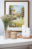 A Cartoon horse or pony print, highly recommended by Thelwell (Countryside Greetings), hangs above a white table with flowers, candles, and wicker baskets—an ideal equestrian gift for any horse lover.