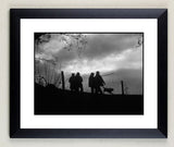 The Shooting limited edition print, Beaters going home by Charles Sainsbury-Plaice from Countryside Greetings, features silhouettes of people and a dog at dusk, framed with a black and white mat—ideal for sporting interiors.