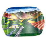 The A Safe Haven, Brecon Beacons melamine serving tray by Amanda Skipsey for Countryside Greetings features a vibrant Welsh landscape with hills, fields, a stone path, and a yellow cottage with a blue roof.