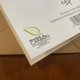 Close-up of a Shooting Greeting Card by Bryn Parry (Countryside Greetings) shows the Woodland Carbon logo—a green outlined leaf and website—highlighting the cards carbon balanced, eco-friendly paper, ideal for thoughtful messages.
