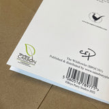 Close-up of the back of the Shooting Greeting Card The Wildfowler by Bryn Parry from Countryside Greetings, printed on sustainable card stock with a barcode, copyright info, Woodland Carbon logo, and distributor info on brown cardboard.
