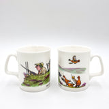 CountrysideGreetings Bone China Shooting Mug, The Glorious Twelfth, features a white mug with Bryn Parry-style cartoon art of a hunter aiming his rifle, set against a classic white background and handle.