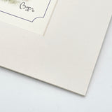 Close-up of the bottom right corner of a matted Chocolate Labrador limited edition print by Bryn Parry from Countryside Greetings, showing the off-white beveled mat, part of the printed border, and the artist’s black ink signature.