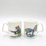 Two CountrysideGreetings Bone China Collectible Fly Fishing mugs feature Bryn Parrys artwork: one with an elderly man casting, the other with a leaping fish bridging both. Exclusively from Countryside Greetings—perfect for fishing enthusiasts.