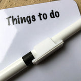 The Slim magnetic memo dry wipe Things to do board—Teamwork by Bryn Parry from CountrysideGreetings—features a glossy, light-reflective surface with an attached white marker, making it a practical British-made gift for any workspace.