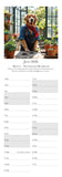 Dog calendar for July 2026 with a dog wearing a sweater and scarf on a table.