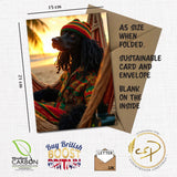 A5 greeting card featuring a Standard Poodle dressed in reggae clothing, sitting in a hammock at sunset. The card is shown with a kraft envelope and labelled with dimensions (15 cm x 21 cm). Text highlights include: A5 size when folded, sustainable card and envelope, blank on the inside. Logos for Woodland Carbon, Buy British Boost Britain, and Countryside Greetings are also shown.