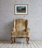 Horse racing print in frame above arm chair